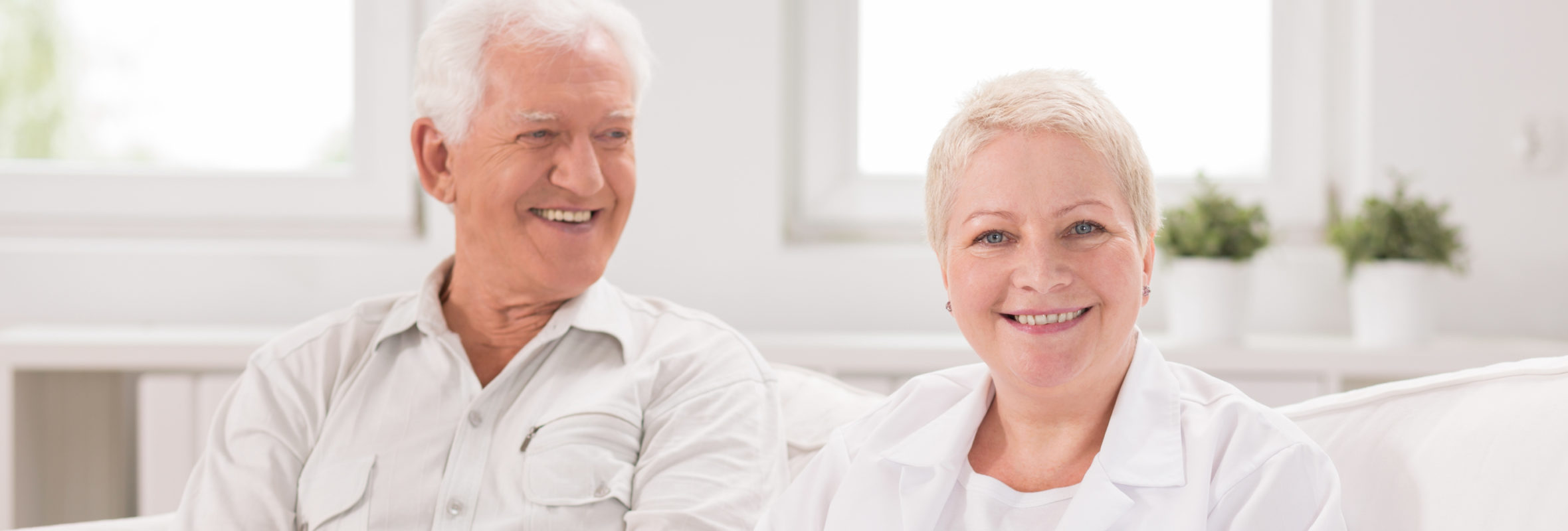 Dental Implants - Senior man and adult nurse in white