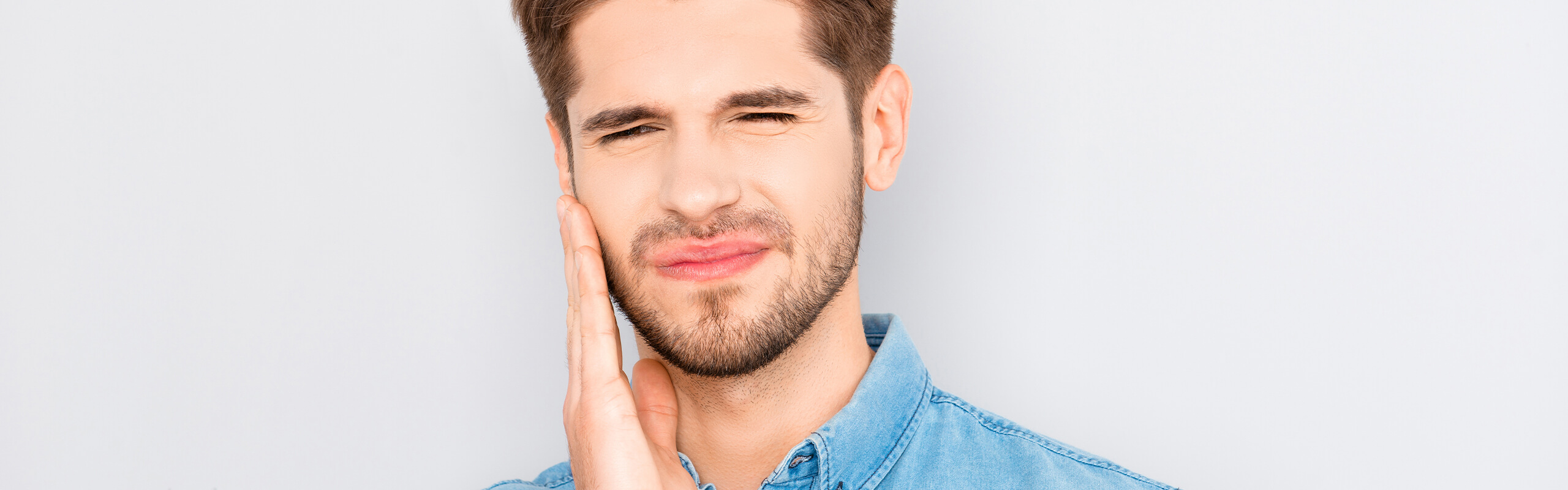 Man holding face with tooth pain