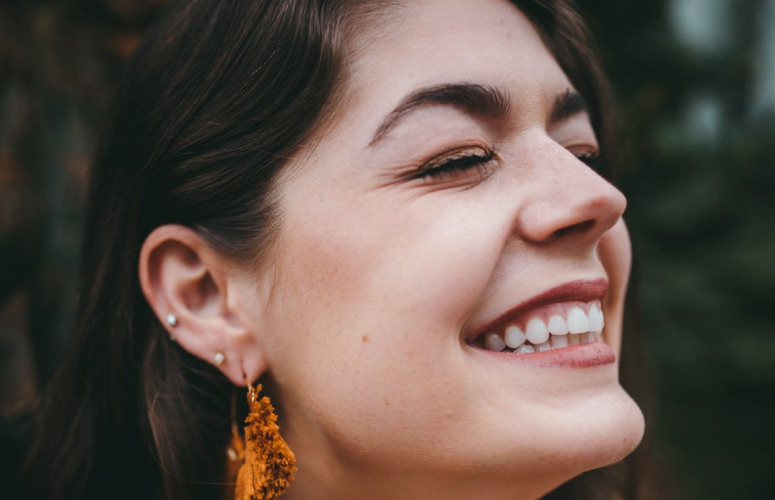 dark haired girl with a big toothy smile