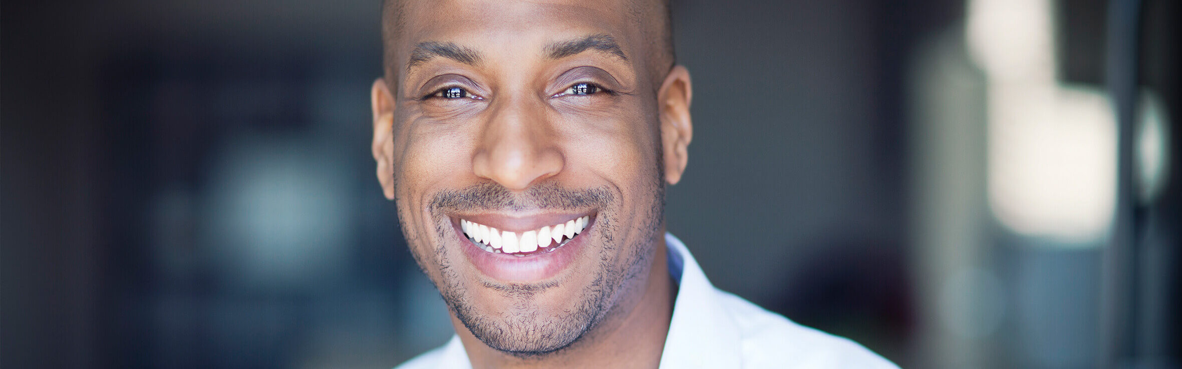 man smiling after getting a good night's sleep